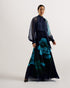 MANAMI-Dresses-The MANAMI maxi dress exudes glamour from head to toe, starting with a classic bow tie around the neck and ending with a fine pleated skirt. Floral details are printed on this piece to add an understated splash of colour, finished out with sheer bishop sleeves and a full hem to create plenty of swish. Maxi dress Large scale floral print details High neck with pussybow tie Sheer long bishop sleeves Pleated A-line skirt Front split Concealed zip fastening Chae is 5'9.5" / 1.77m and wears a Ted